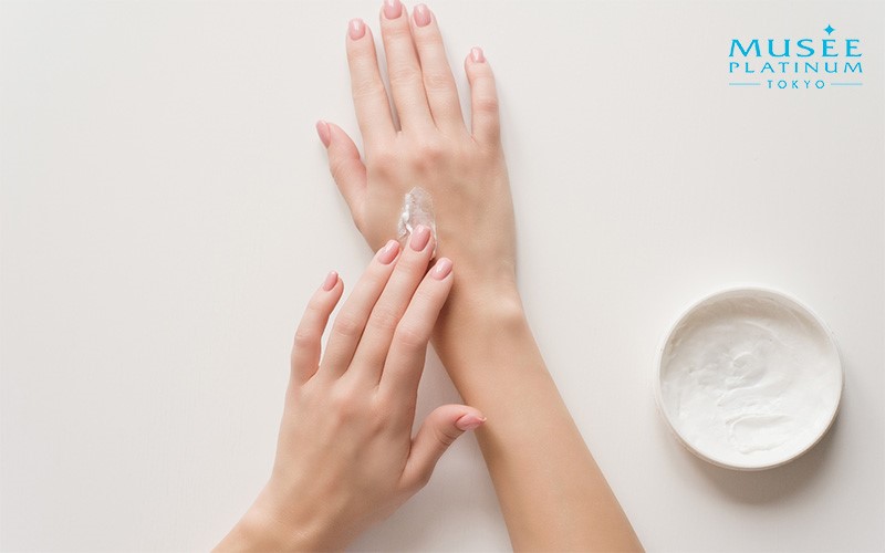 Woman applying cream on her hand