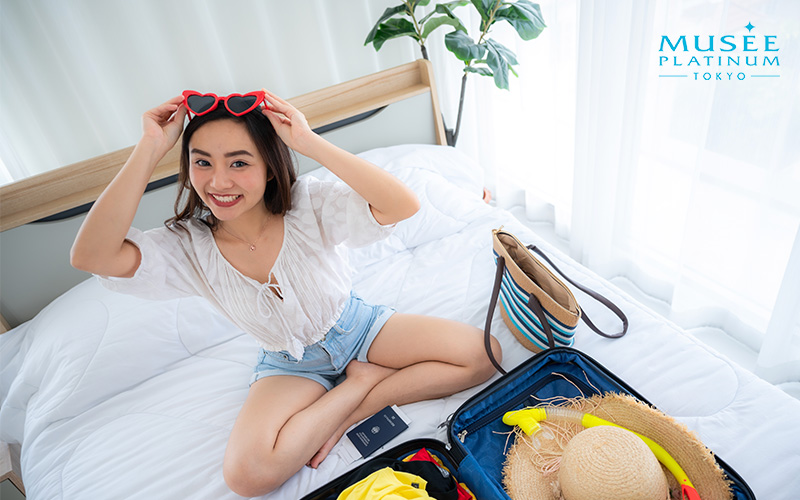 Young happy woman getting ready for a summer vacation