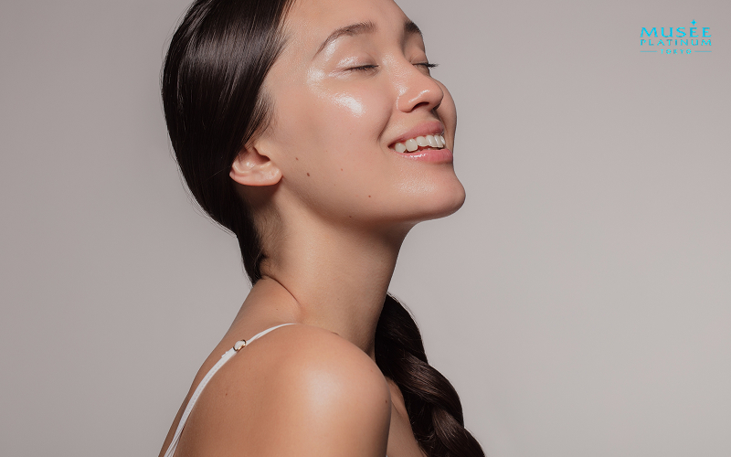 Smiling woman with glowing, hydrated skin after brightening treatment